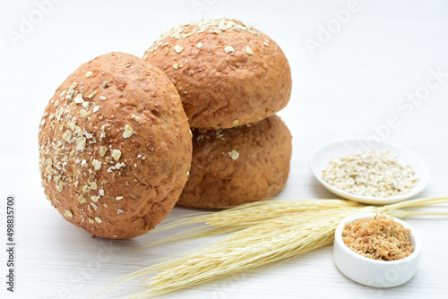 Round wholemeal oat bread, sweetened with natural panela, displayed on white wood