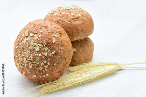 Round wholemeal oat bread, sweetened with natural panela, displayed on white wood