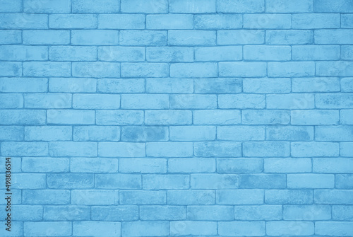 Brick wall painted with pale blue paint pastel calm tone texture background. Brickwork interior design element. 