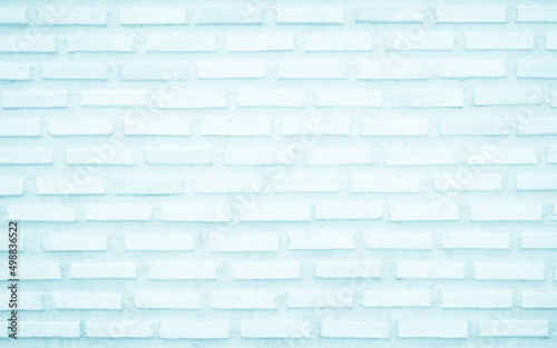 Brick wall painted with pale blue paint pastel calm tone texture background. Brickwork interior design element. 