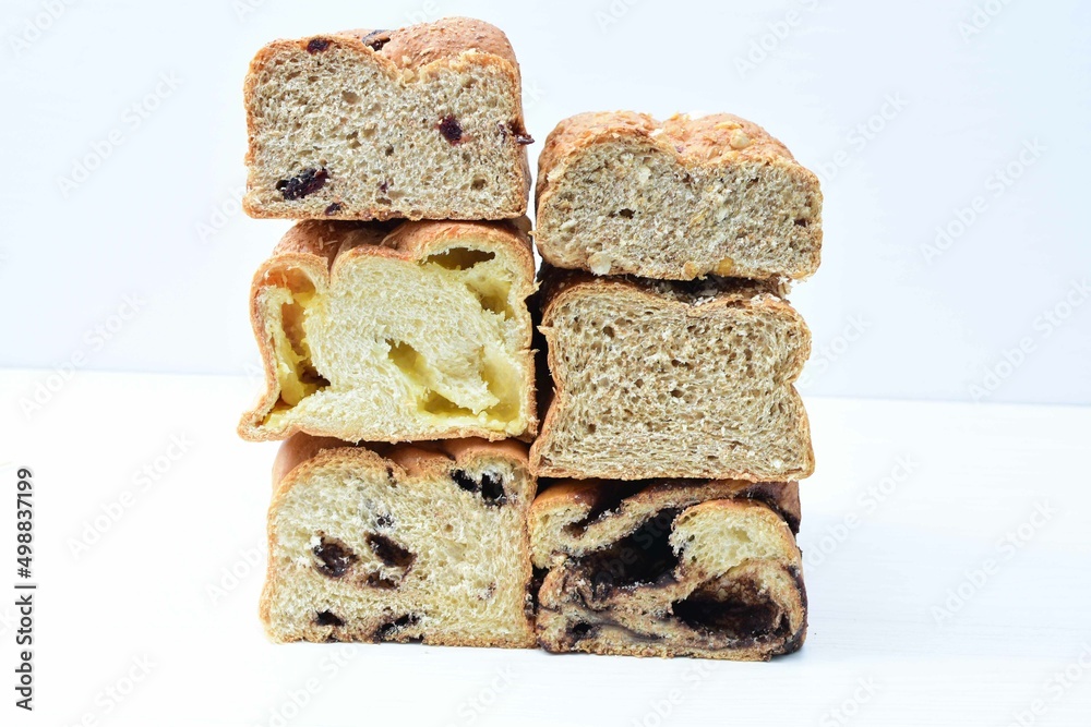 Mix of artisan breads of different natural flavors, displayed on a wooden background Mix of artisan breads of different natural flavors, displayed on a wooden background
