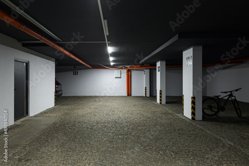 Parking lot of a multi-storey building. Underground parking for residents of a modern house.