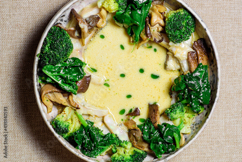 Bowl with delicious mushroom soup with cream and broccoli