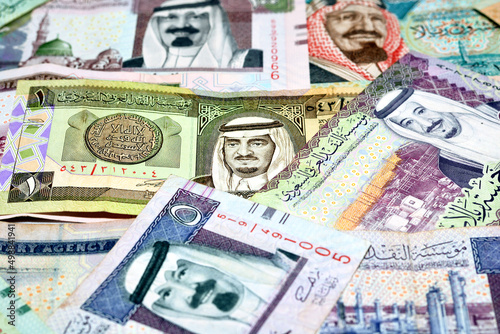 Background of a pile of Saudi Arabia riyals banknotes money bills of different values from different times, selective focus of a stack of Saudi riyals, kingdom of Saudi Arabia economy concept photo