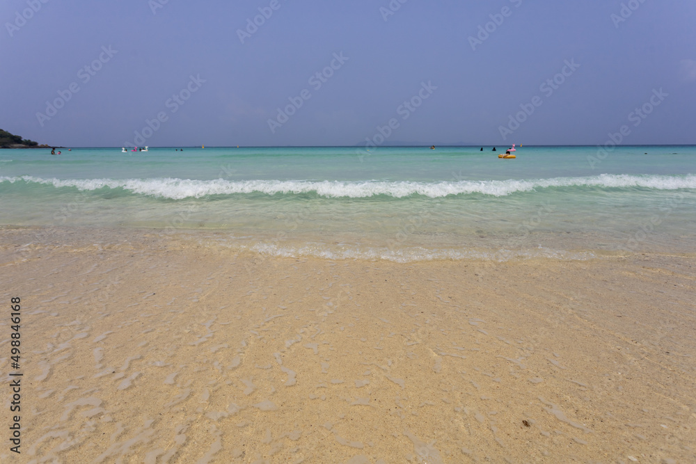 beach and sea wave on the white sand beach and space on blue sky on sunny day