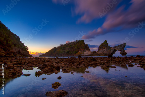beautiful sunrise scenery of unique rock island at atuh beach nusa penida, bali © tonjung