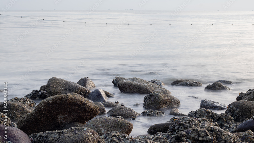 Waves crashing against rocks - water flowing over rocks Waves crashing against rocks - water flowing over rocks