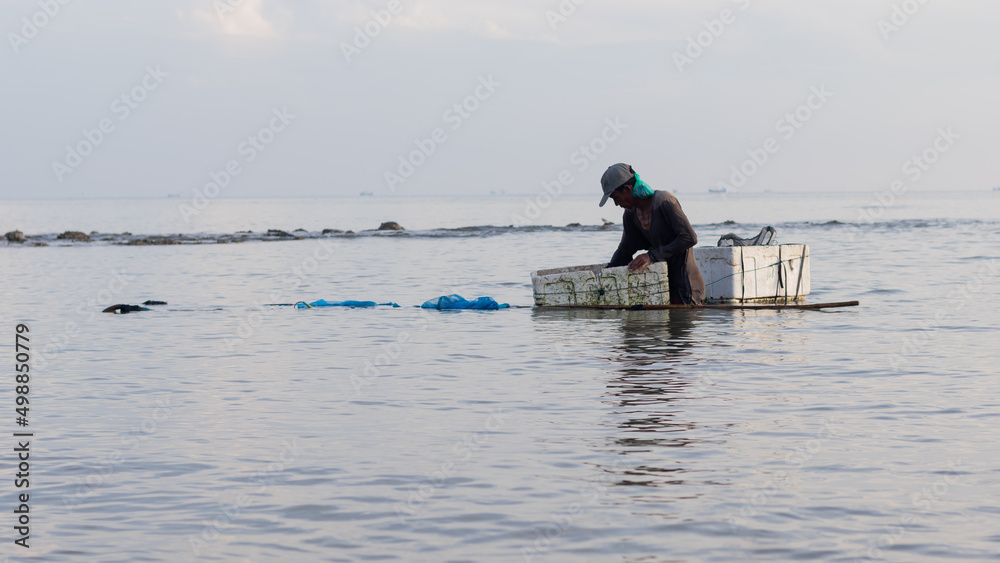 Shrimp fisherman carrying catch with Styrofoam Shrimp fisherman carrying catch with Styrofoam