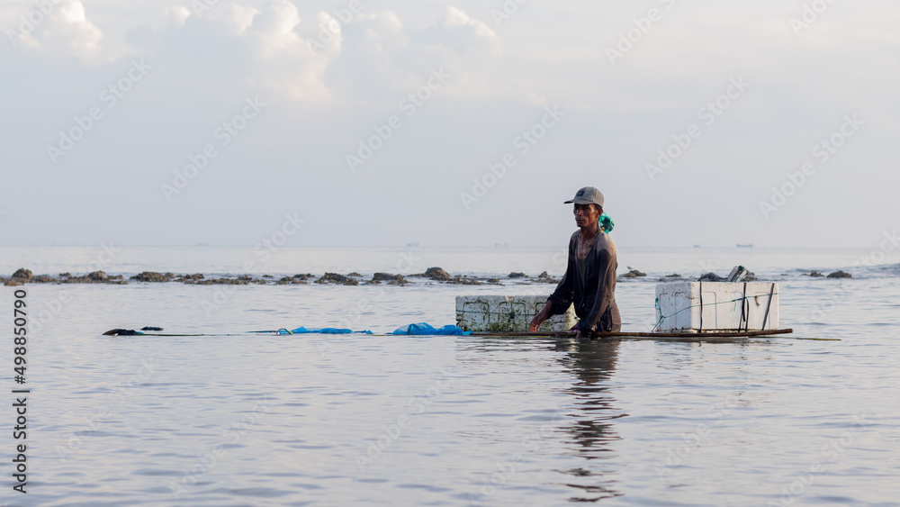 Shrimp fisherman carrying catch with Styrofoam