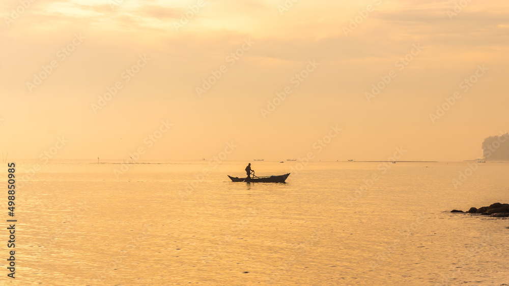 Silhouette of people with sea view and boats at sunrise in Medan, Indonesia, 2022 Silhouette of people with sea view and boats at sunrise in Medan, Indonesia, 2022