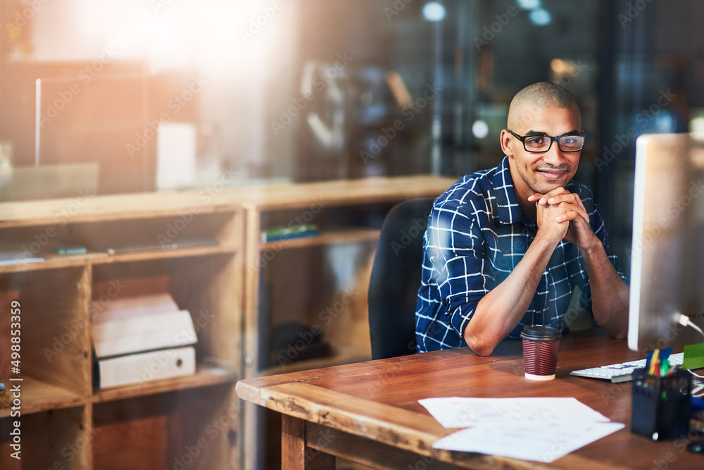 Hes been making huge strides in the creative world. Portrait of a young designer working at his office desk. Hes been making huge strides in the creative world. Portrait of a young designer working at his office desk.