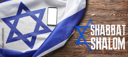 Принти на полотні Flag of Israel, mobile phone and text SHABBAT SHALOM on wooden background