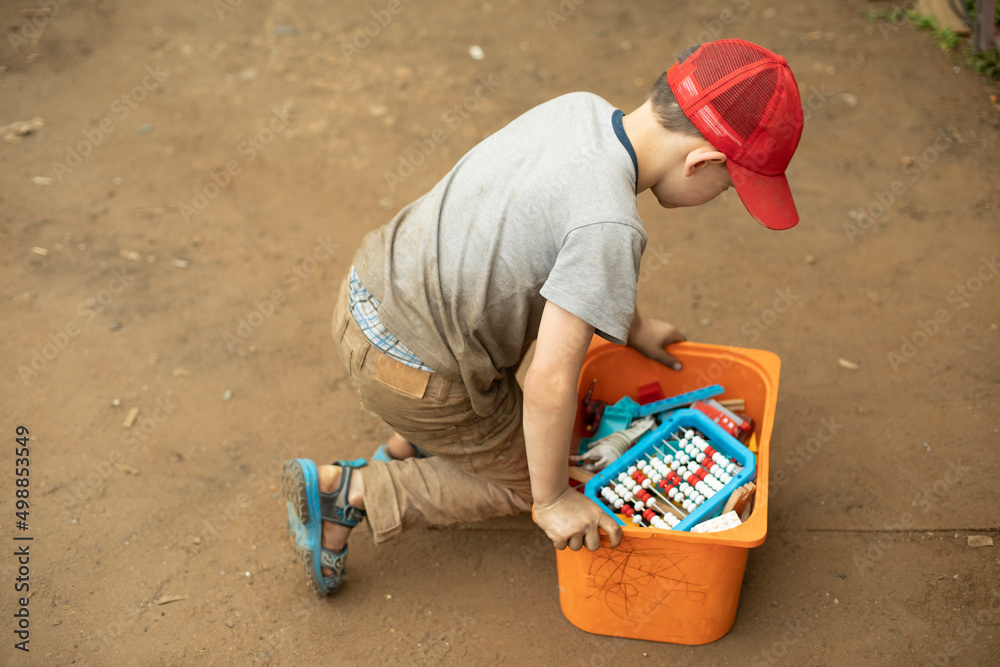 Child collects toys from ground. Boy puts his things in drawer. Preschooler cleans up mess. Child collects toys from ground. Boy puts his things in drawer. Preschooler cleans up mess.