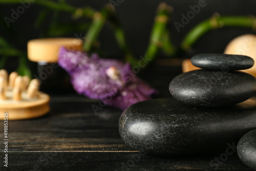 Spa stones on dark wooden background  closeup