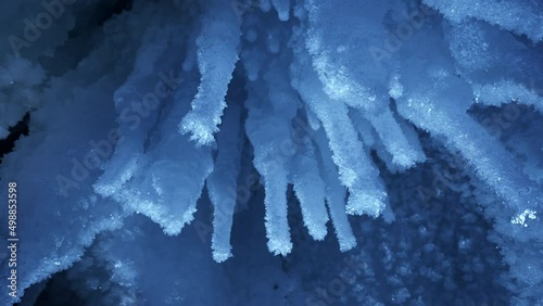 Beautiful crystal icicles, blue sharp ice floes inside frozen grotto  photo