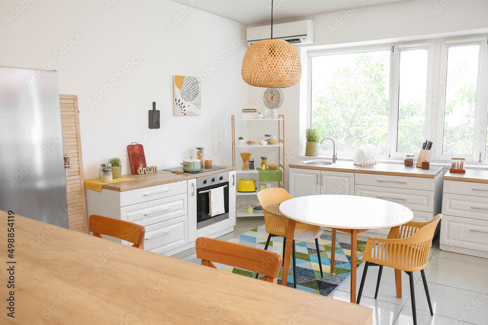Dining table with chairs in modern interior of kitchen Dining table with chairs in modern interior of kitchen