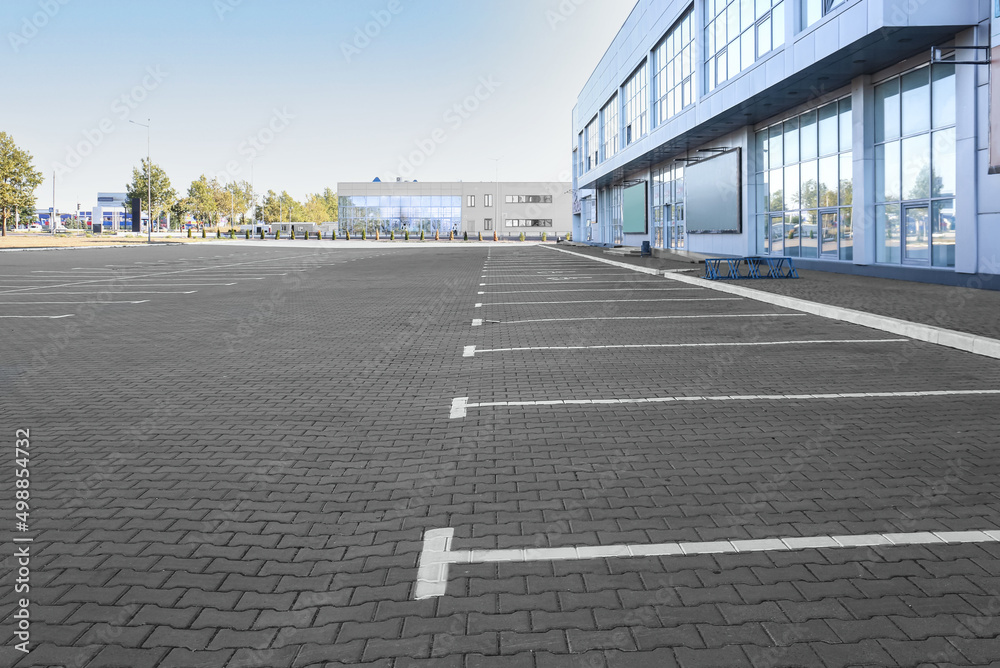 Empty parking lot near supermarket Empty parking lot near supermarket