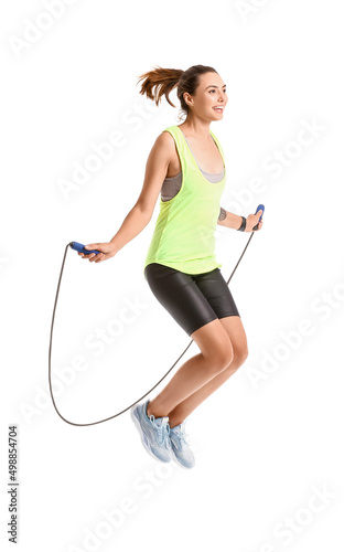 Sporty young woman jumping ...