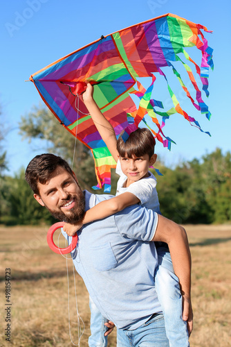 Happy father carrying picka...