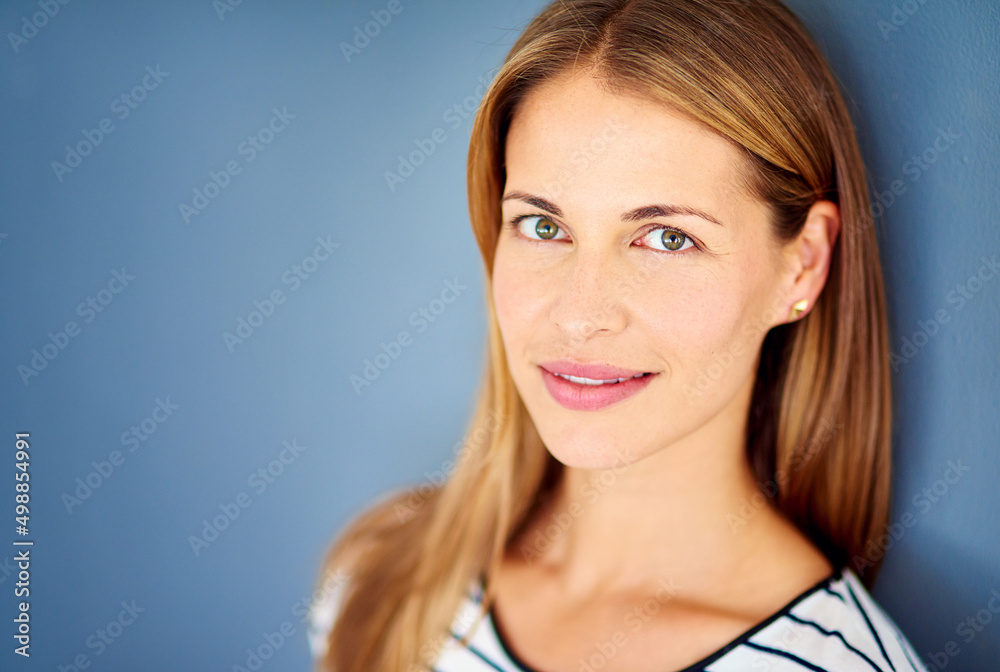 Shes perfectly suited for the business world. Studio shot of a successful businesswoman against a blue background. Shes perfectly suited for the business world. Studio shot of a successful businesswoman against a blue background.