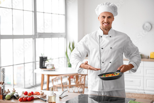 Male chef showing frying pa...