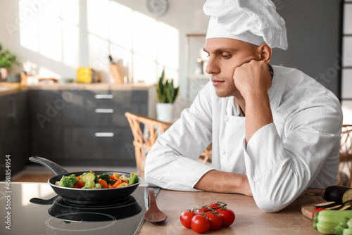 Tired male chef frying tast...