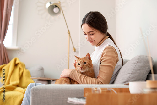 Woman with cute ginger cat ...