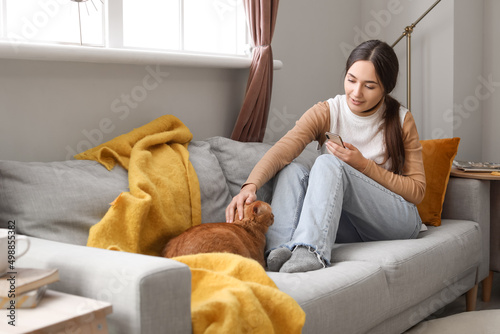 Woman with cute ginger cat ...