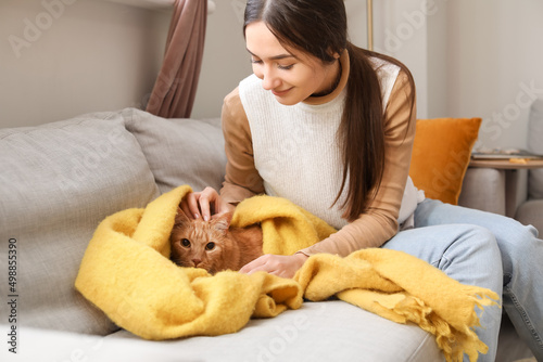 Woman with cute ginger cat ...