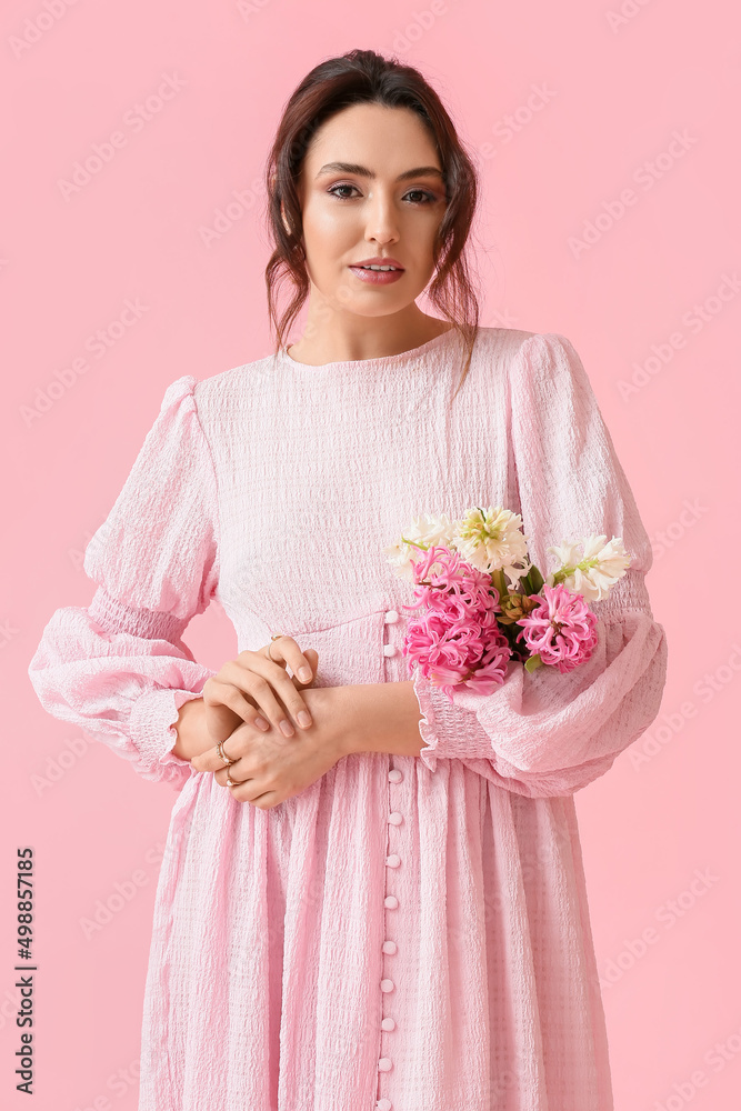Pretty young woman with hyacinth flowers on pink background Pretty young woman with hyacinth flowers on pink background