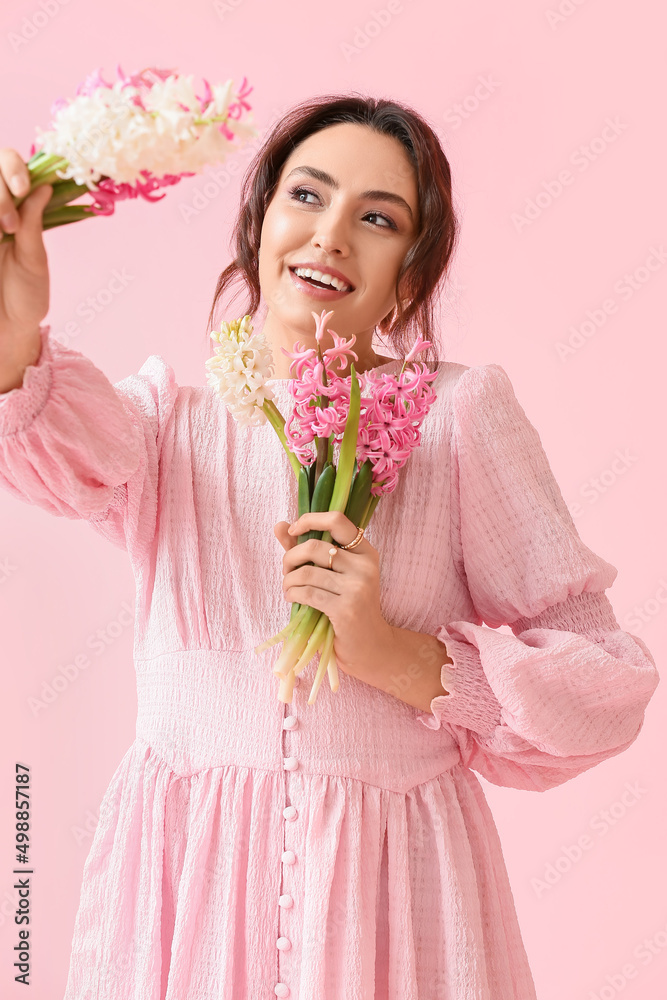 Pretty young woman with hyacinth flowers on pink background Pretty young woman with hyacinth flowers on pink background