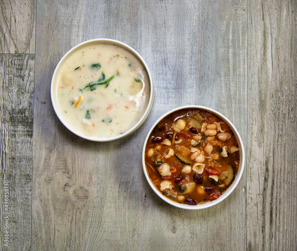 Top view of Minestrone and gnocchi soup bowls. Top view of Minestrone and gnocchi soup bowls.