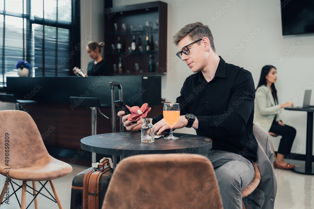 Young businessman waiting for his flight in the lobby area. Young businessman waiting for his flight in the lobby area.