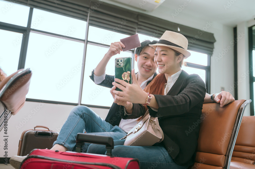 Couple posing for a photo while waiting for their flight in the lobby.