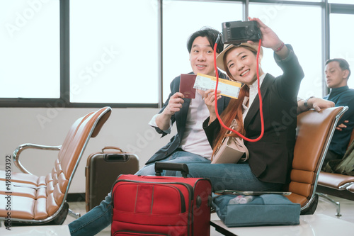Couple posing for a photo while waiting for their flight in the lobby.