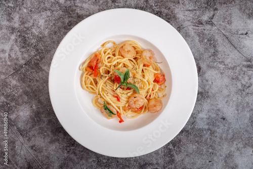 Delicious shrimp spaghetti on a cement table