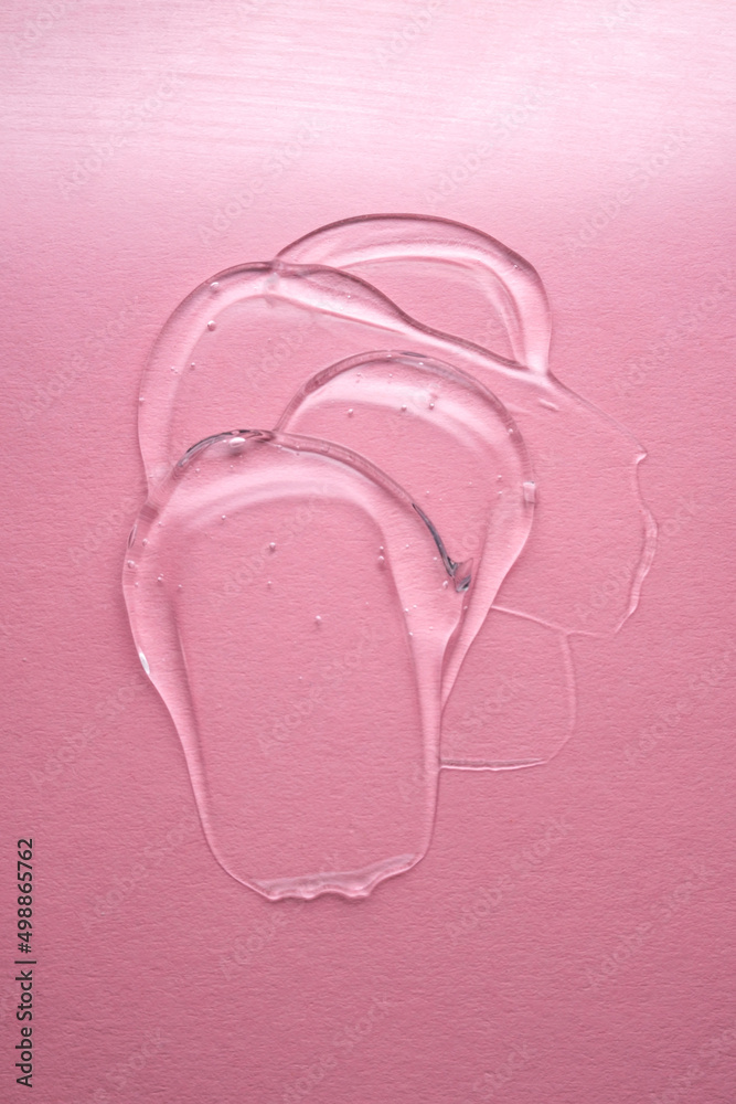 Transparent hyaluronic gel on a pink background. Transparent hyaluronic gel on a pink background.