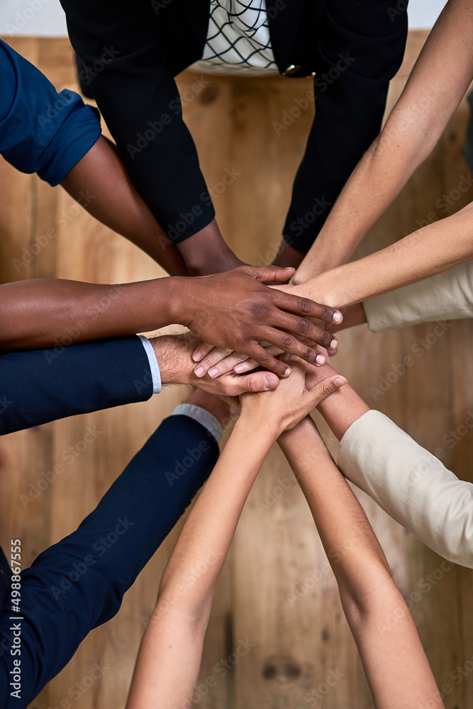 Teamwork brings out our best. High angle shot of a group of unidentifiable businesspeople piling their hands in unity in the office. Teamwork brings out our best. High angle shot of a group of unidentifiable businesspeople piling their hands in unity in the office.