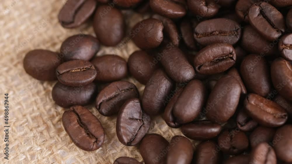 Coffee beans on canvas, close up. Rotation. 4K Coffee beans on canvas, close up. Rotation. 4K