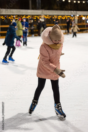 the child was skating on the ice rink