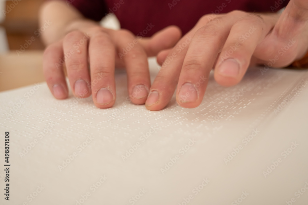 Visually impaired man reading a braille book. Visually impaired man reading a braille book.