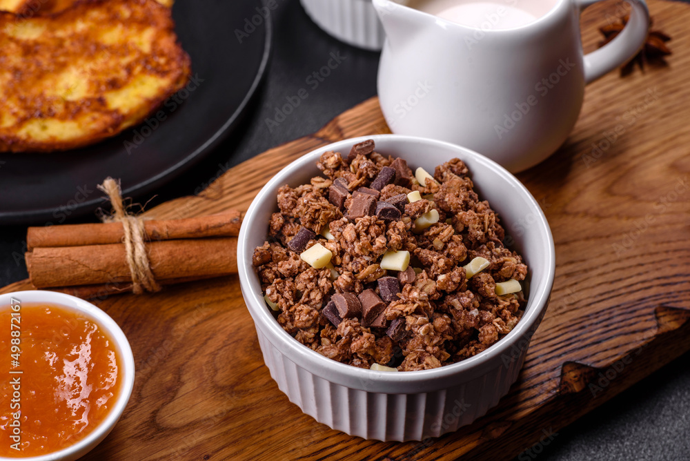 Cereal with chocolate, milk and bread in an egg against a dark concrete background