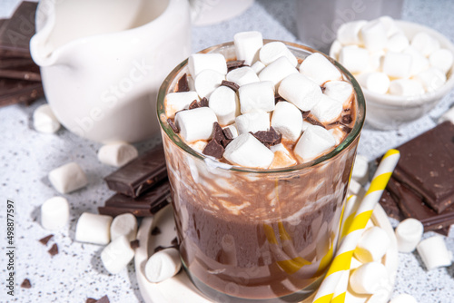 Refreshing Iced Hot Chocolate cocktail, milk sweet chocolate cold drink with marshmallow, white background copy space