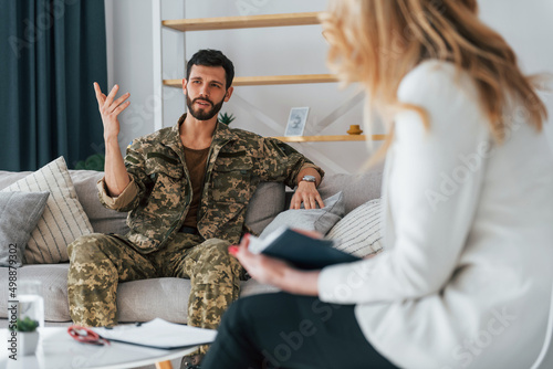 Process of therapy. Soldier is with psychologist indoors
