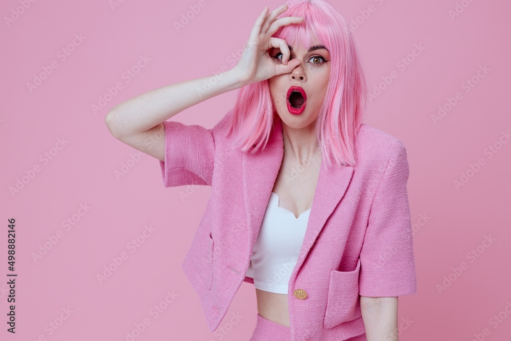 Pretty young female gestures with his hands with a pink jacket pink background unaltered Pretty young female gestures with his hands with a pink jacket pink background unaltered