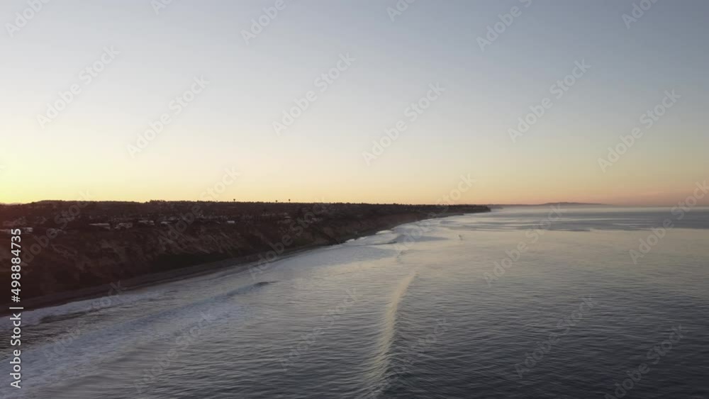 A beautiful aerial drone shot, drone flying along the coast over to the beach during golden hour, Carlsbad State Beach - California