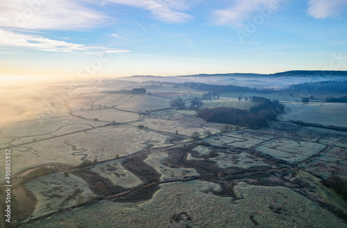 Misty Sunrise over hoarfrosted Wetlands and meadows, RSPB Exminster and Powderham Marshe from a drone, Exeter, Devon, England © Maciej Olszewski