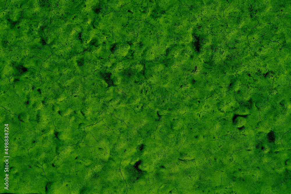 Green cracked paint of a swimming pool bottom. Green abstract background. Moody green. Green cracked paint of a swimming pool bottom. Green abstract background. Moody green.
