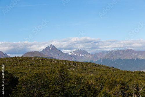 Mountain peaks covered with snow and hills with grass and vegetation