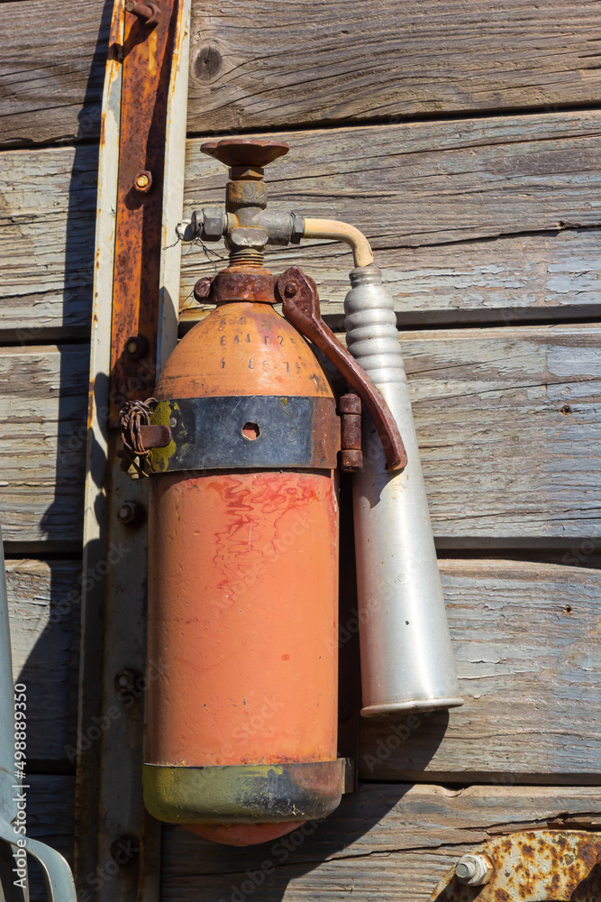 old and grunge wooden wall mounted fire extinguisher background and texture old and grunge wooden wall mounted fire extinguisher background and texture